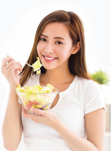 Women posing with salad bowl